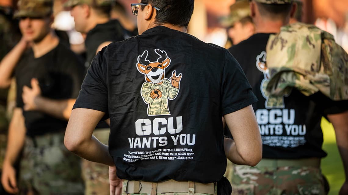 Backside of ROTC cadets wearing black shirts with Thunder the GCU mascot saying GCU wants you