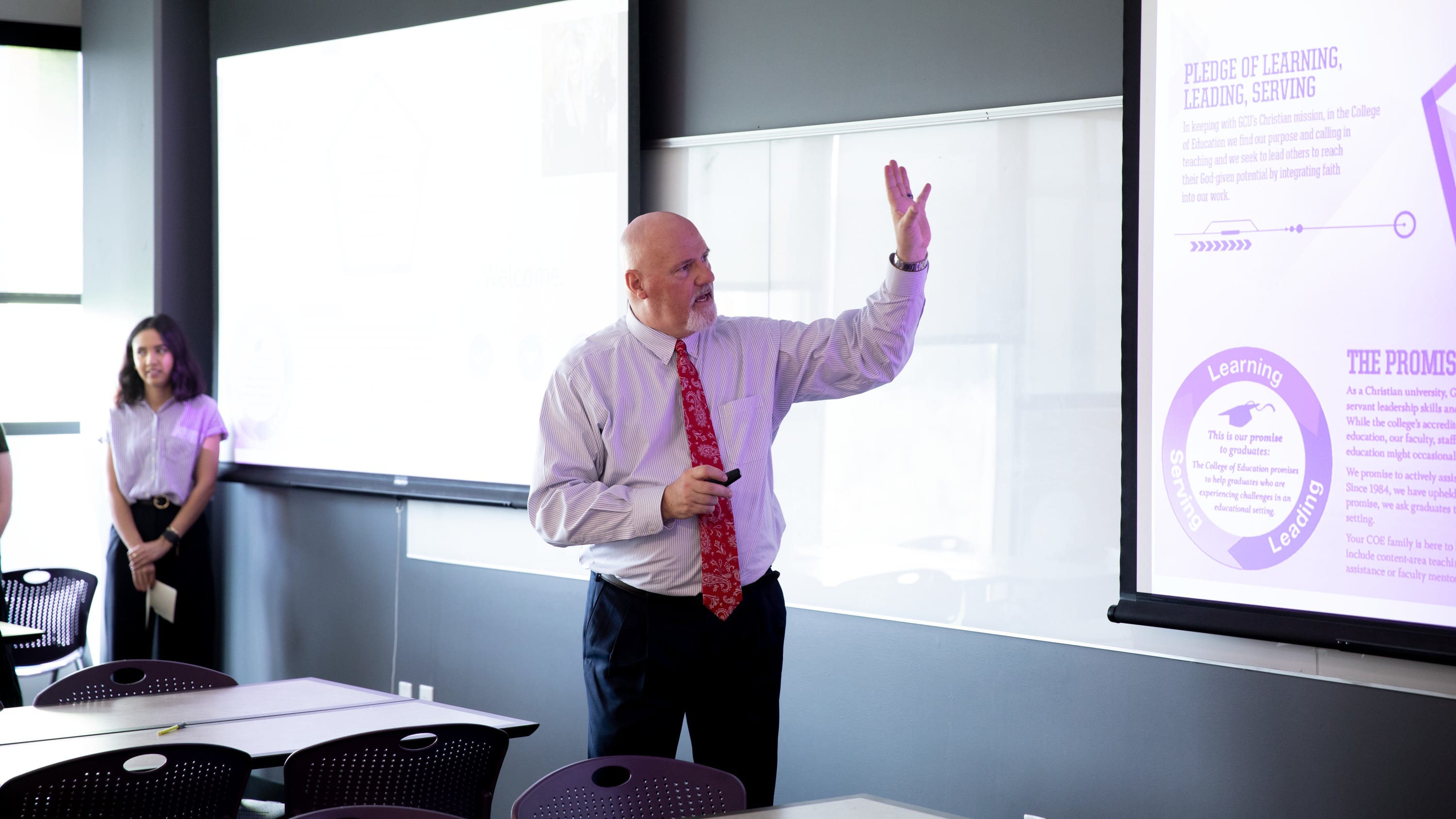 Faculty pointing to the projector screen