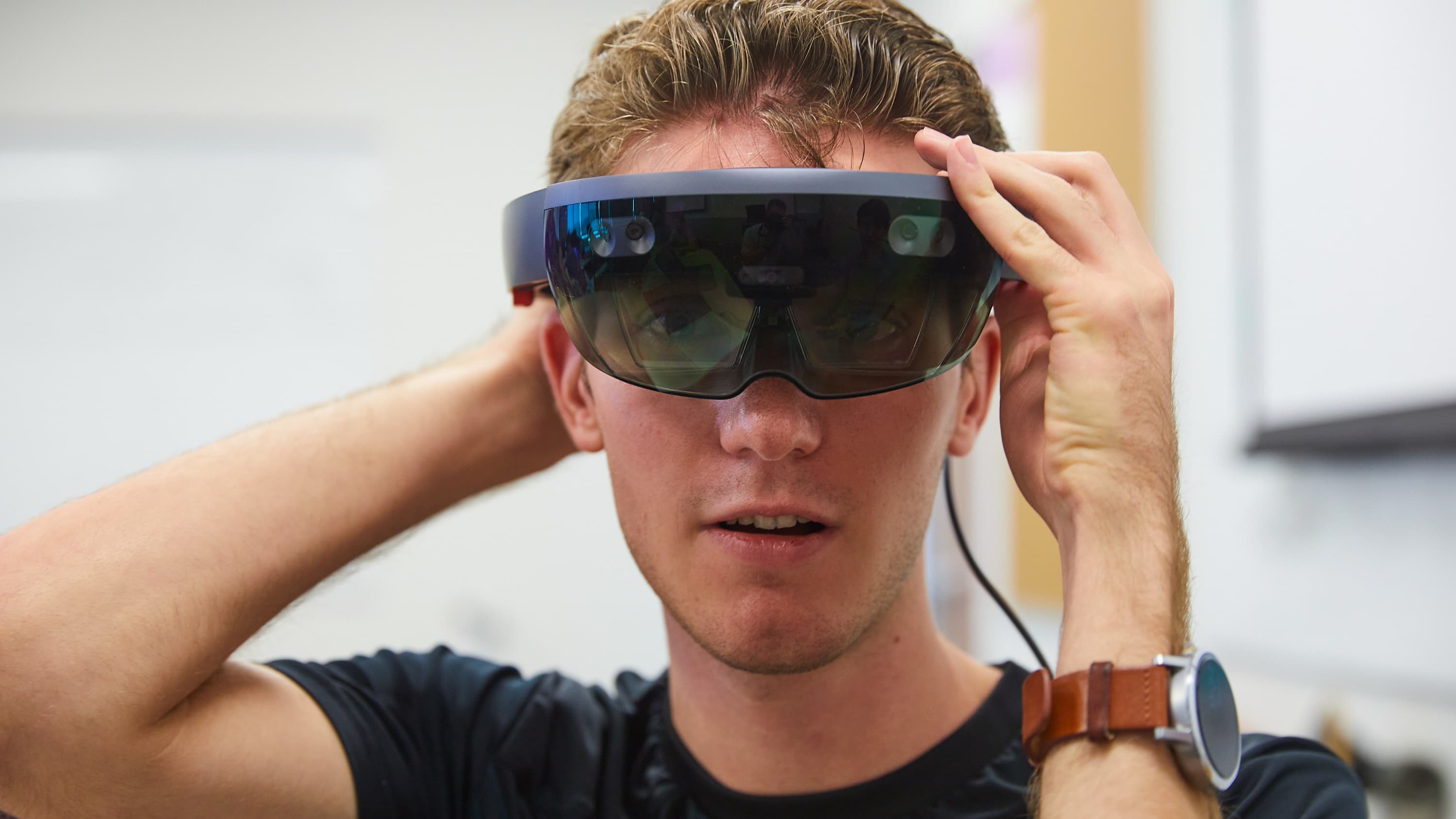 Male technology degree student wearing VR glasses in Lopes Live Lab at GCU