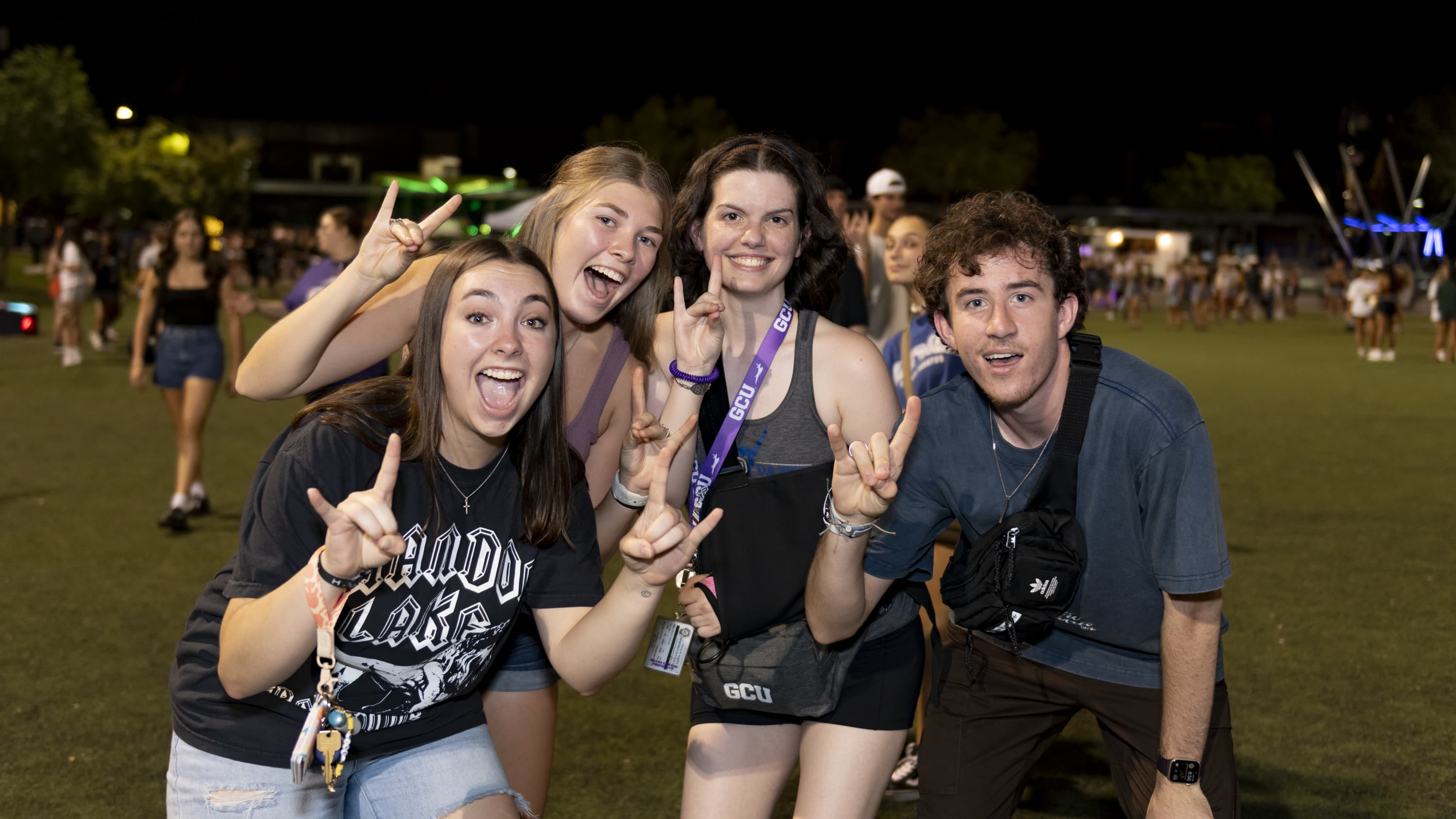 Students celebrating together, smiling and showing Lopes Up