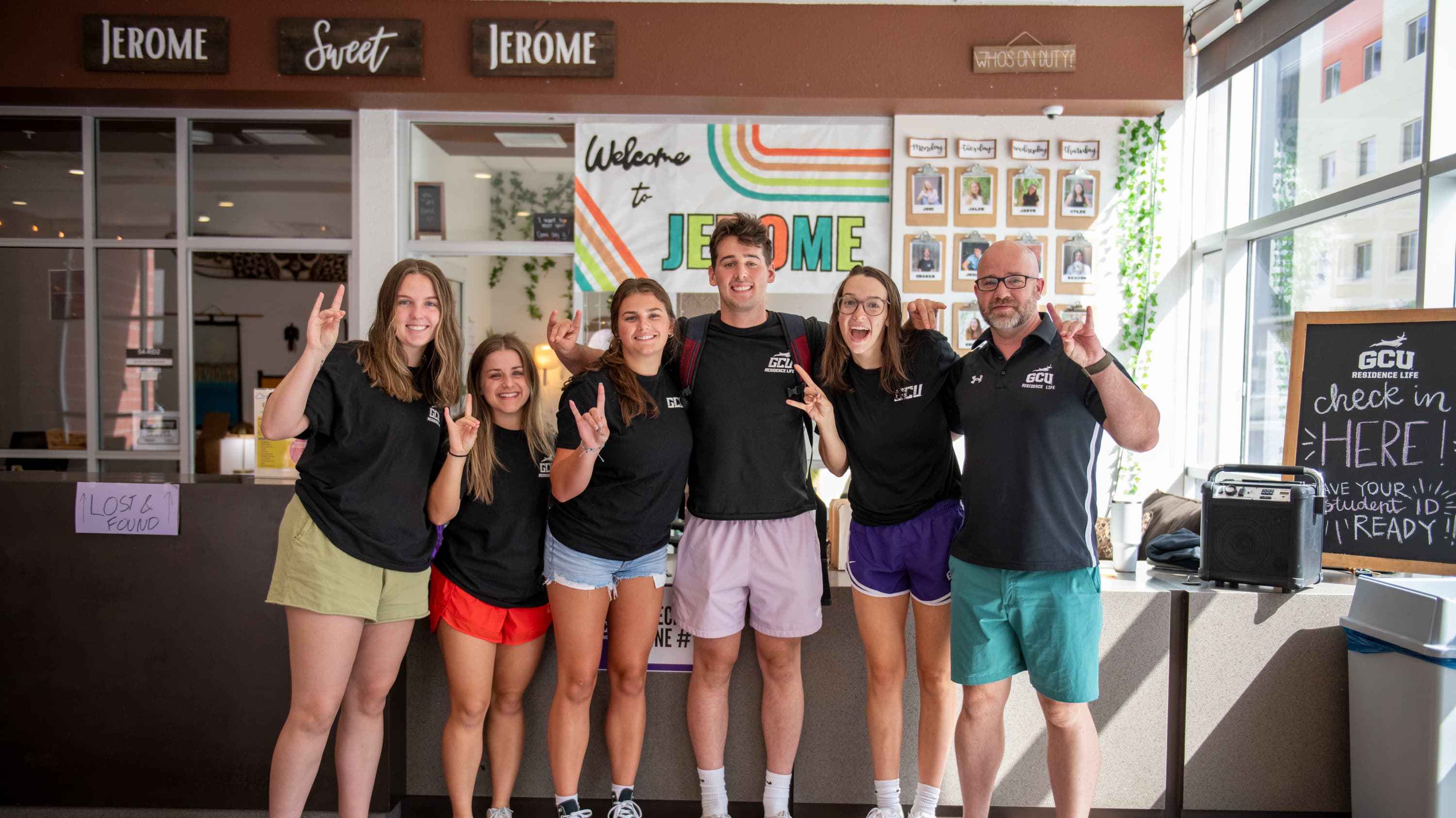 Residents posing in front of apartment lobby