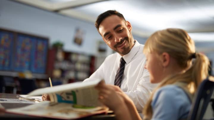 a teacher helping a young student