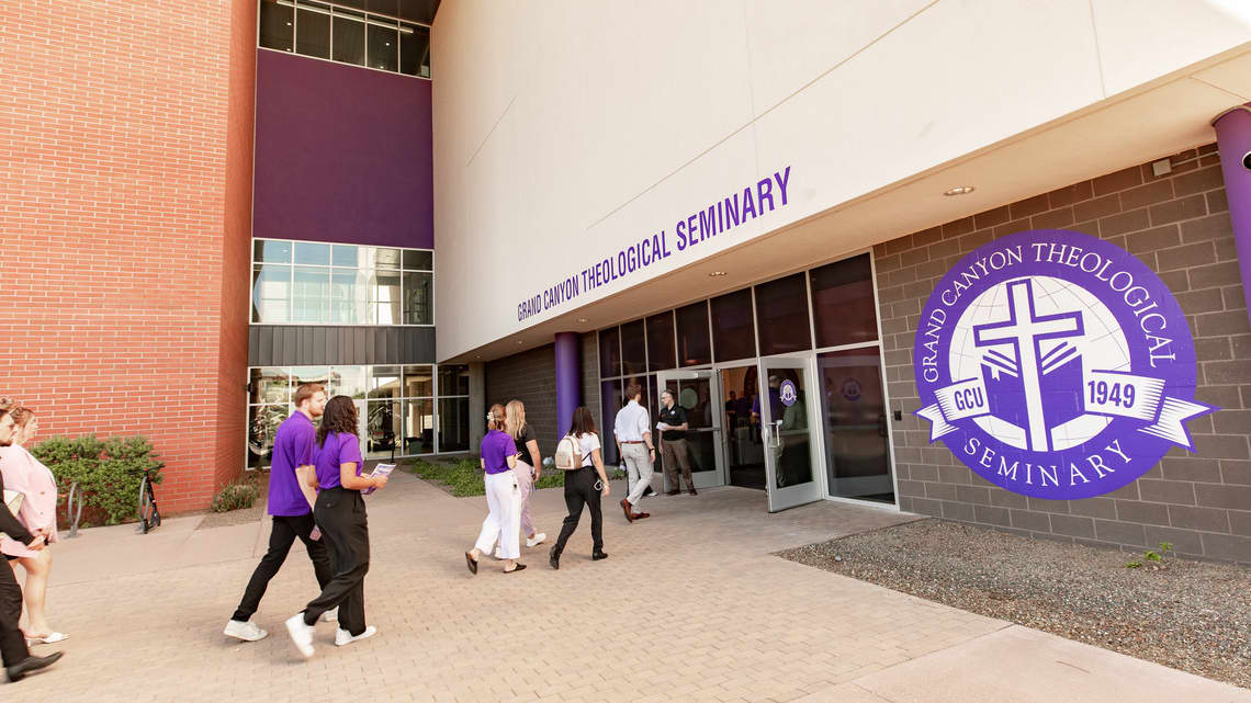 People walking into the grand opening ceremony of the Grand Canyon Theology Seminary new location