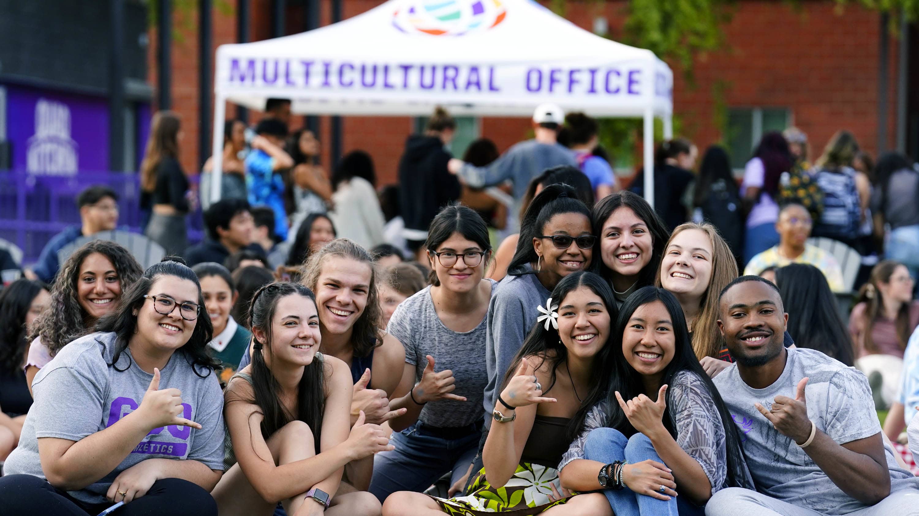 students pose for a picture on one of GCU's lawns during a campus event