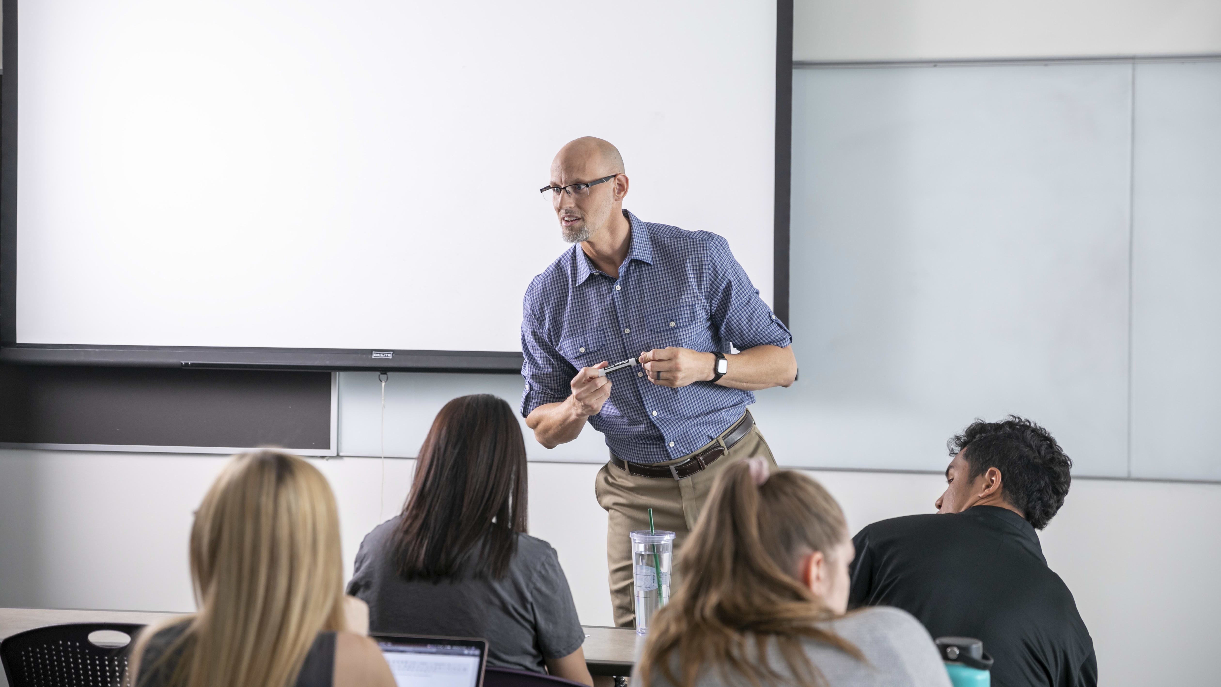 Secondary education teacher speaking with class