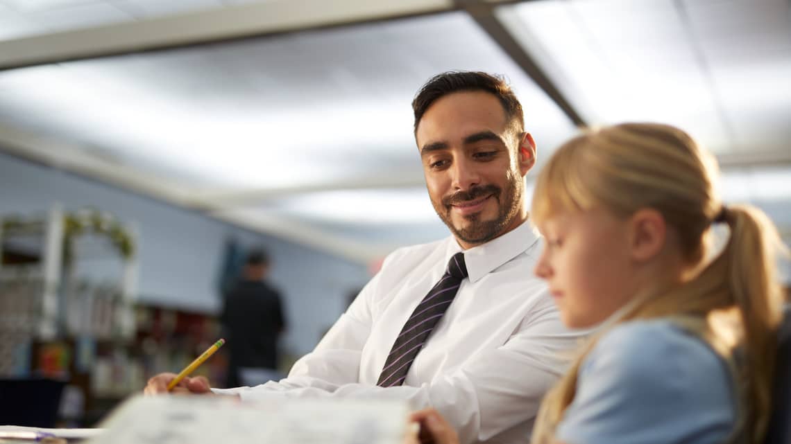 Speech language works with student 1 on 1 in classroom
