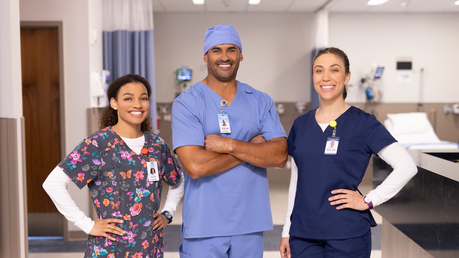 Male and female healthcare professionals smiling together in hospital