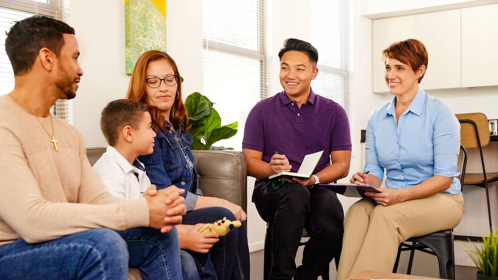 School Counselors Meet With Student and Parents in Office