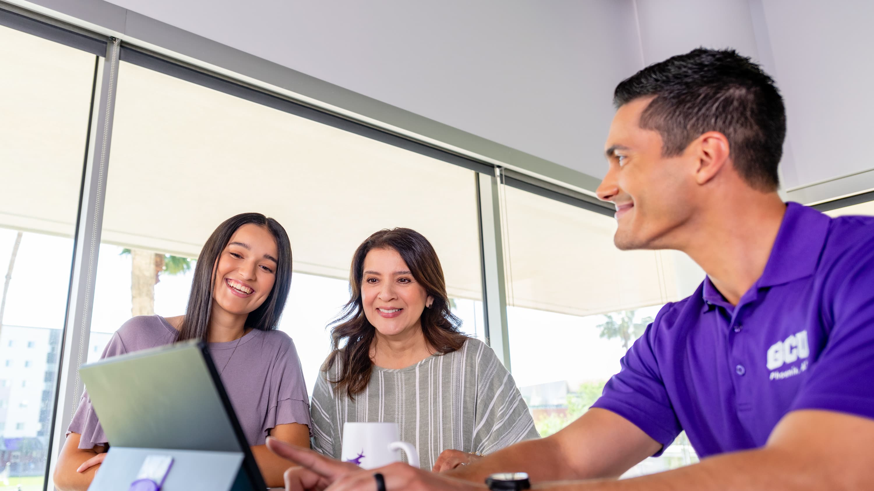 Two GCU students talking with counselor 