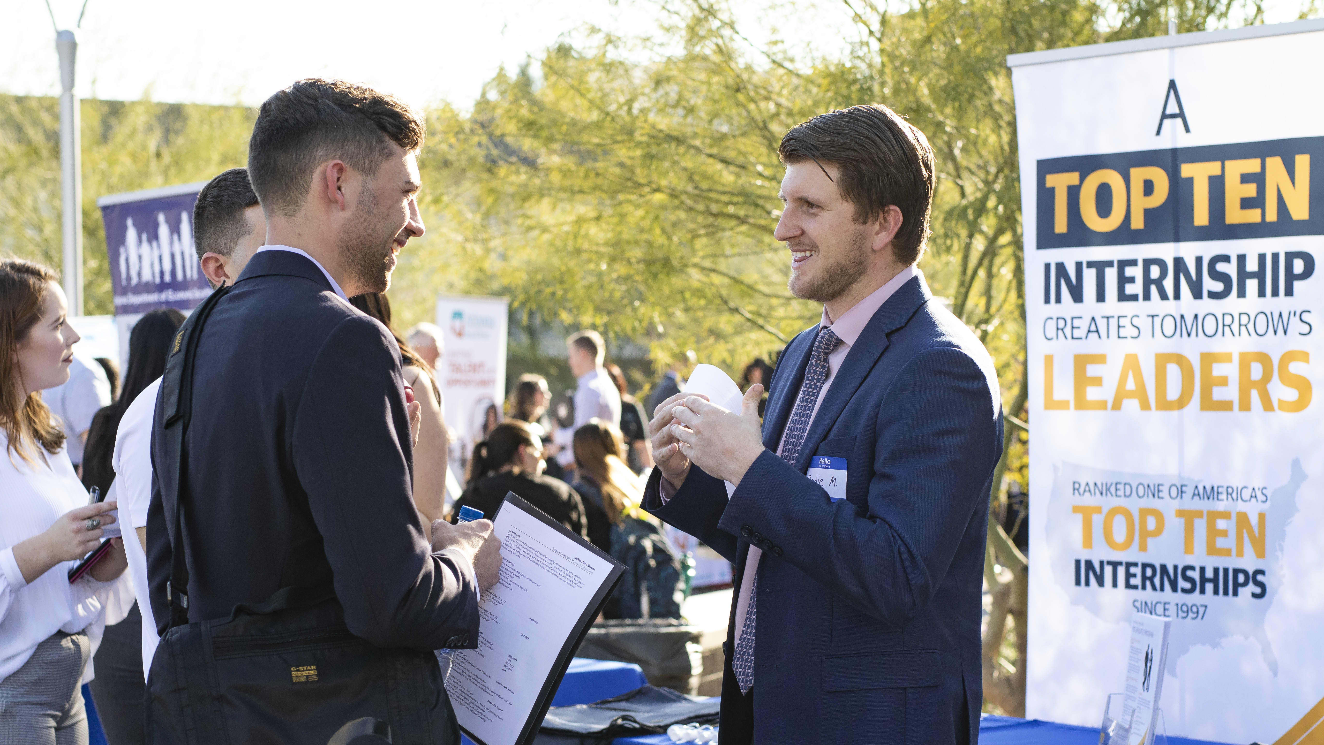 Employer speaking with student at GCU career fair