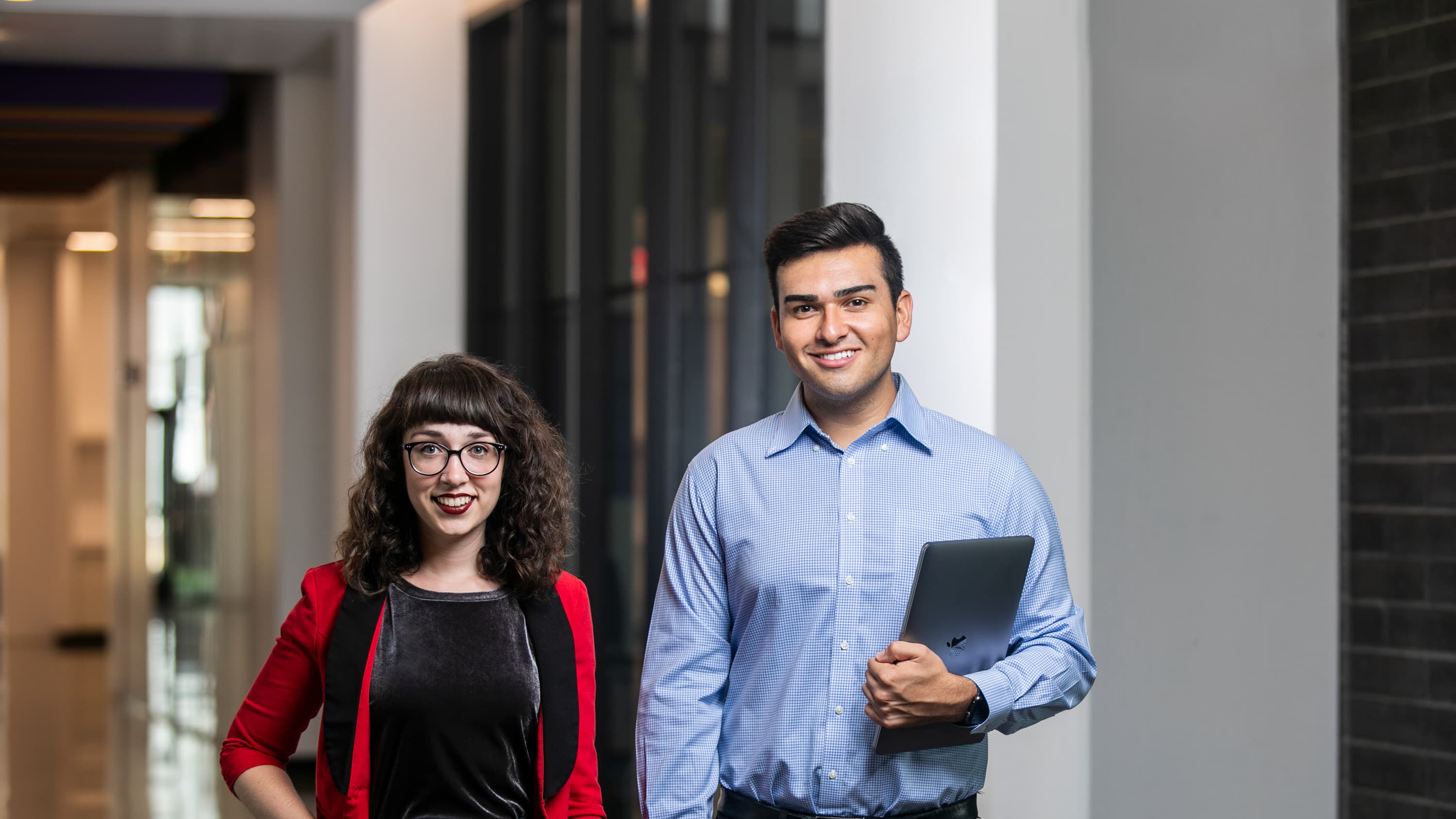 Male and female MS in Criminal Justice degree students walking in GCU hallway