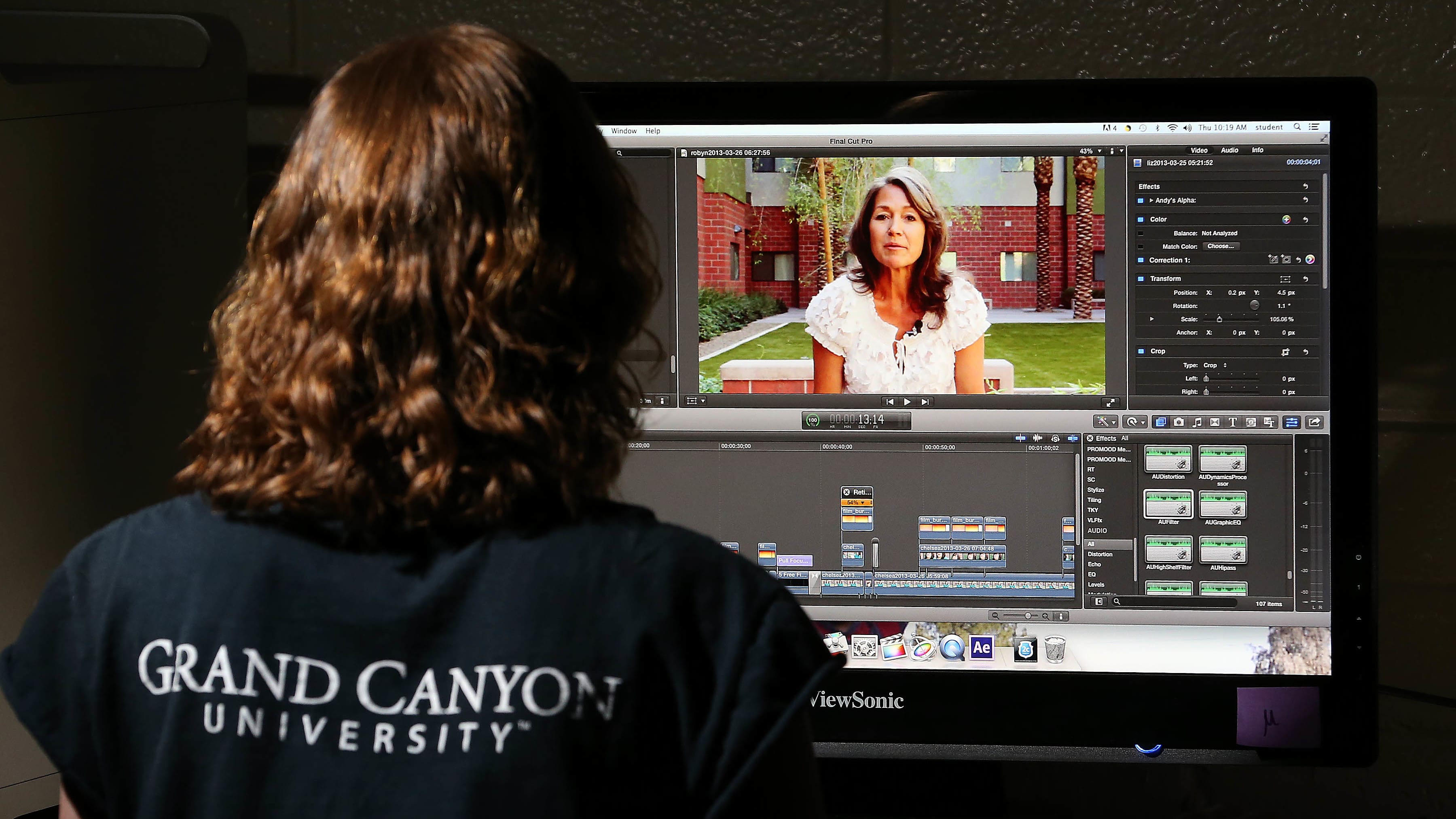 Female digital media degree student working in GCU computer lab on film project