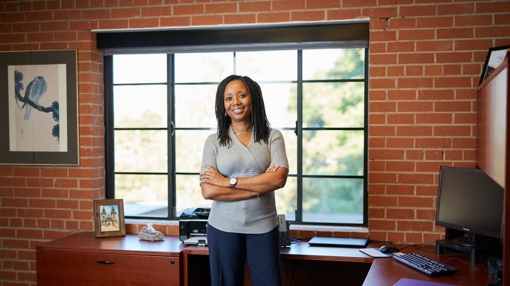 EdD Degree Holder Poses Standing in Her Office 