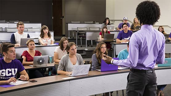 Teacher speaking in front of a class