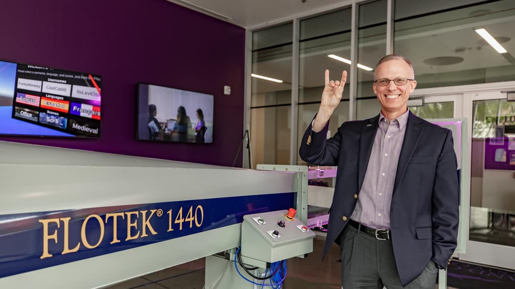 Engineer Shows Lopes Up Sign and Smiling for Photo