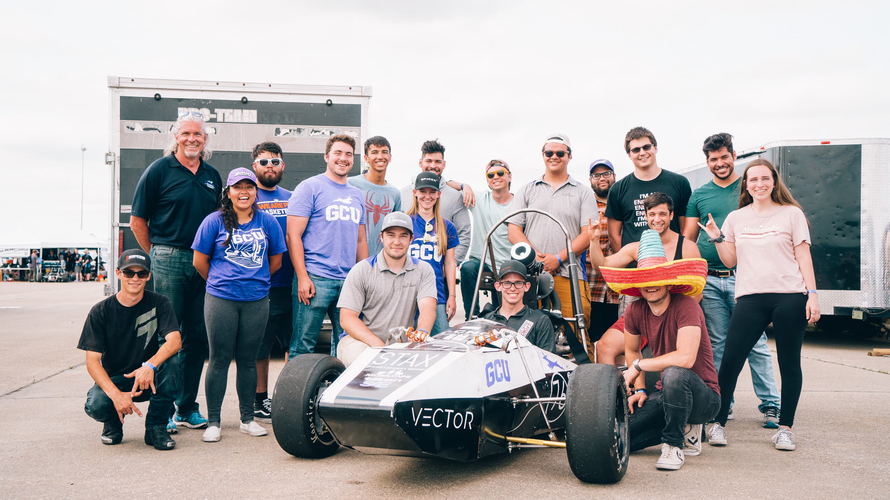 Group of industrial engineering degree students smiling with capstone engineering project