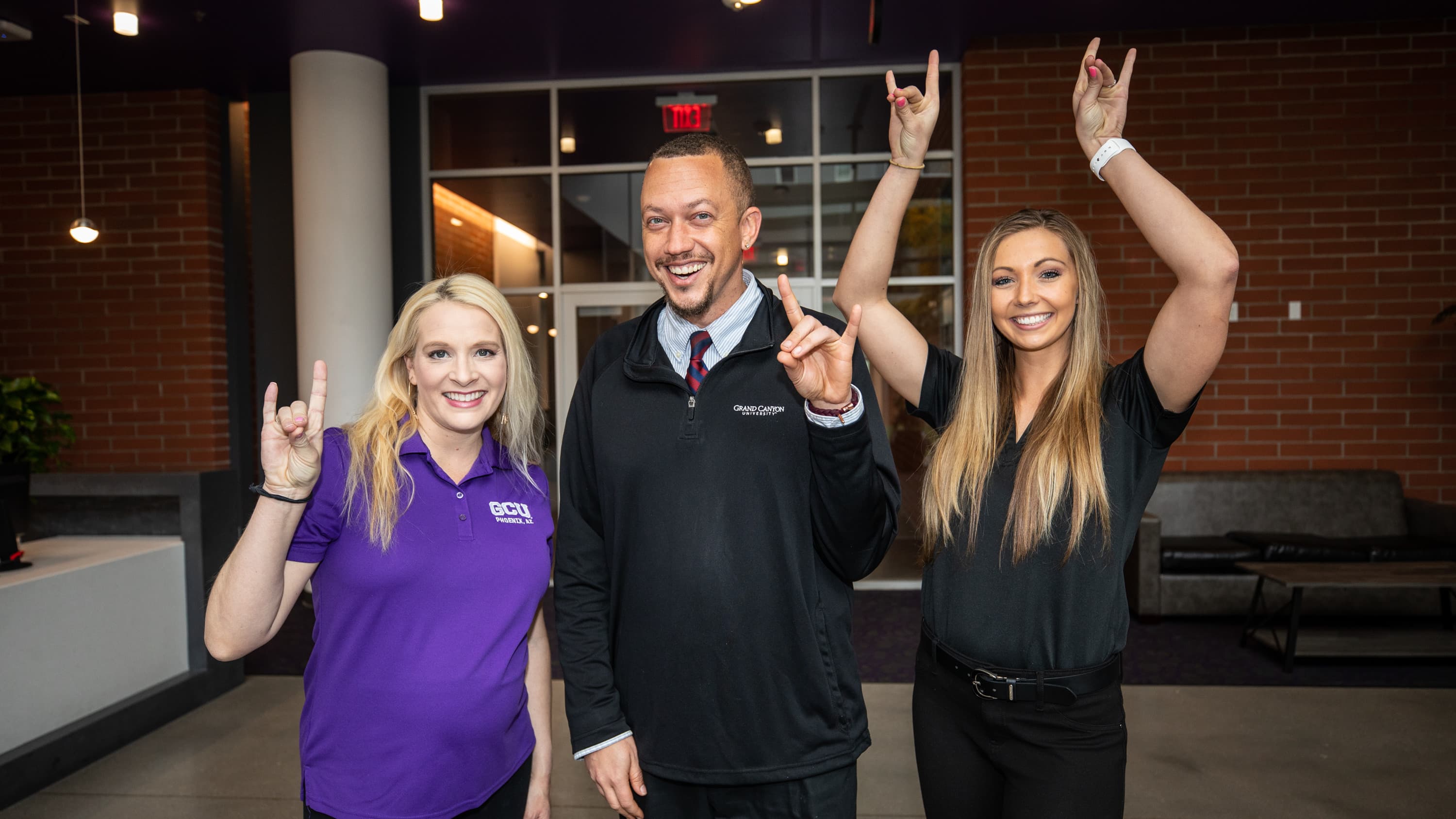 GCU counseling students smiling and holding Lopes Up hand sign