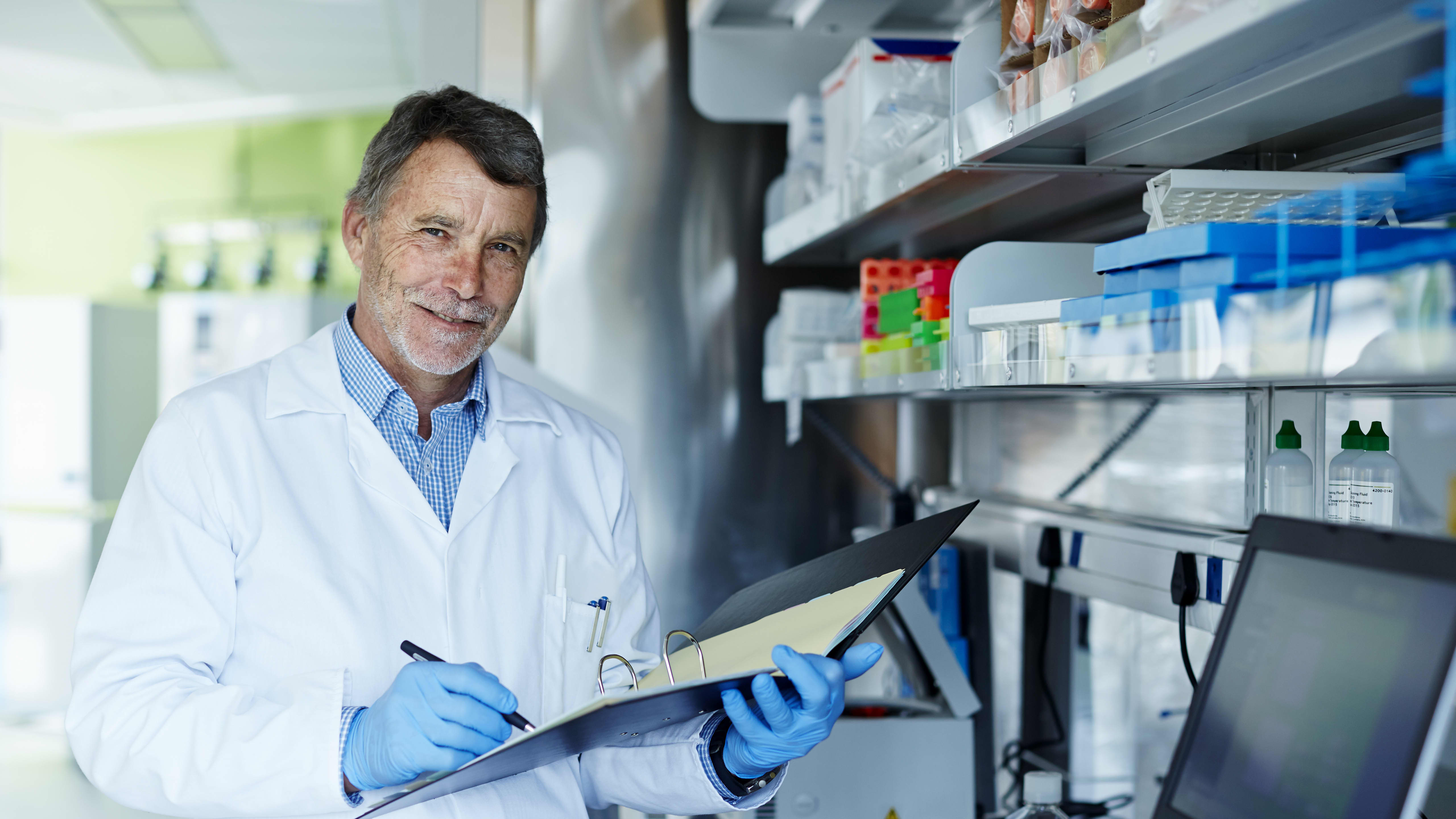 Autopsy Technician Fills Out Notes and Looks Positively at Camera