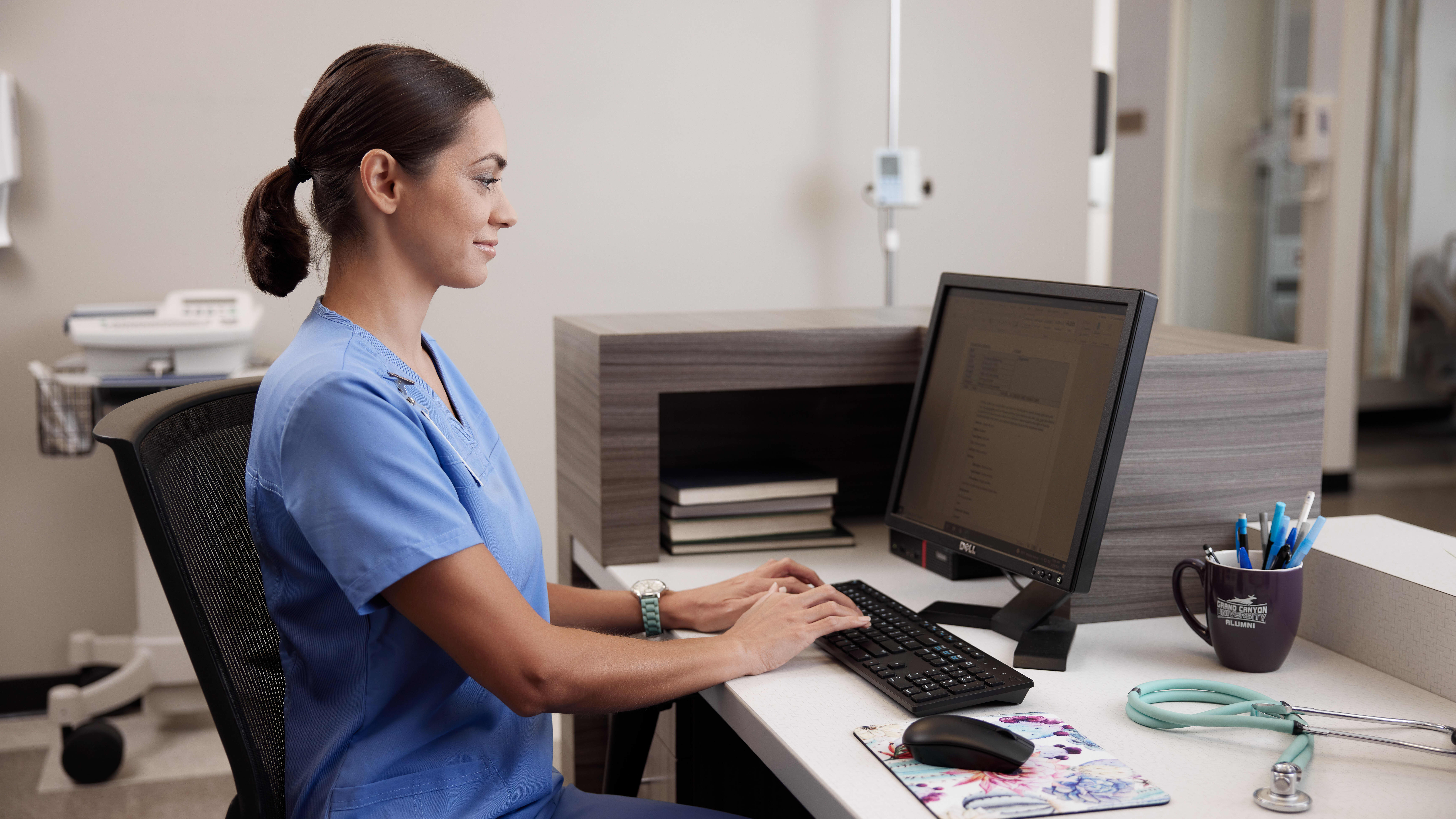 Graduate nursing student working at computer