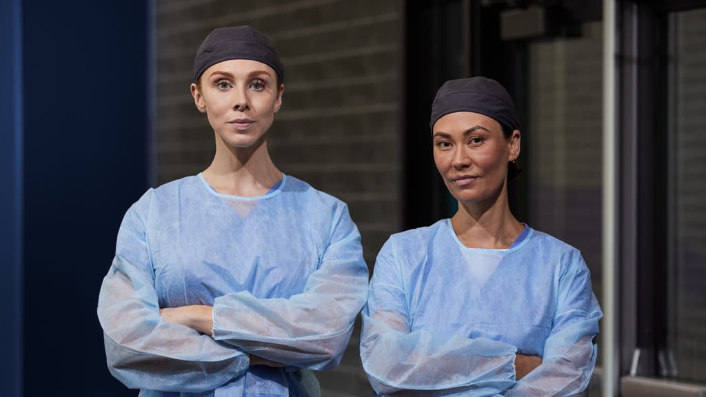 Two Nursing Leaders Pose for Picture in Scrubs