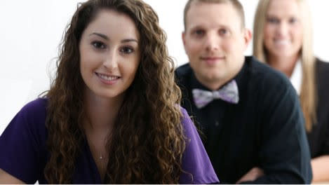 Male and female master's degrees students smiling in classroom at GCU