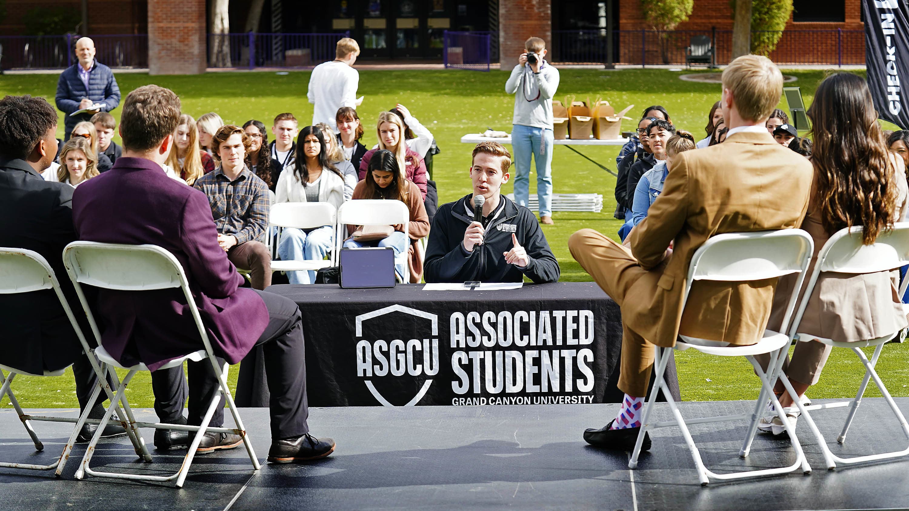 ASGCU candidates sitting on stage during Meet the Candidates event