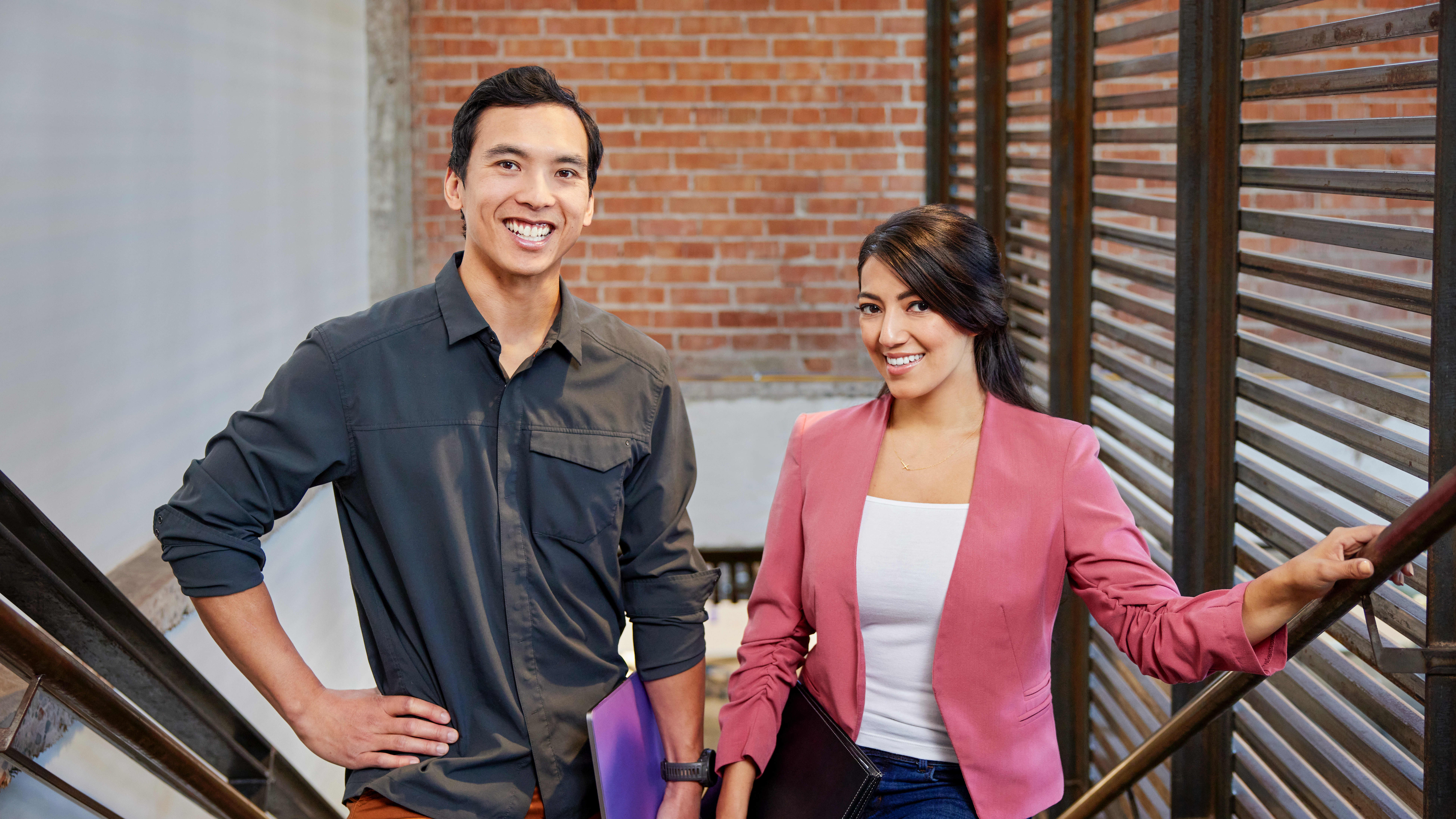 Male and female doctoral students walking on steps to night class at GCU