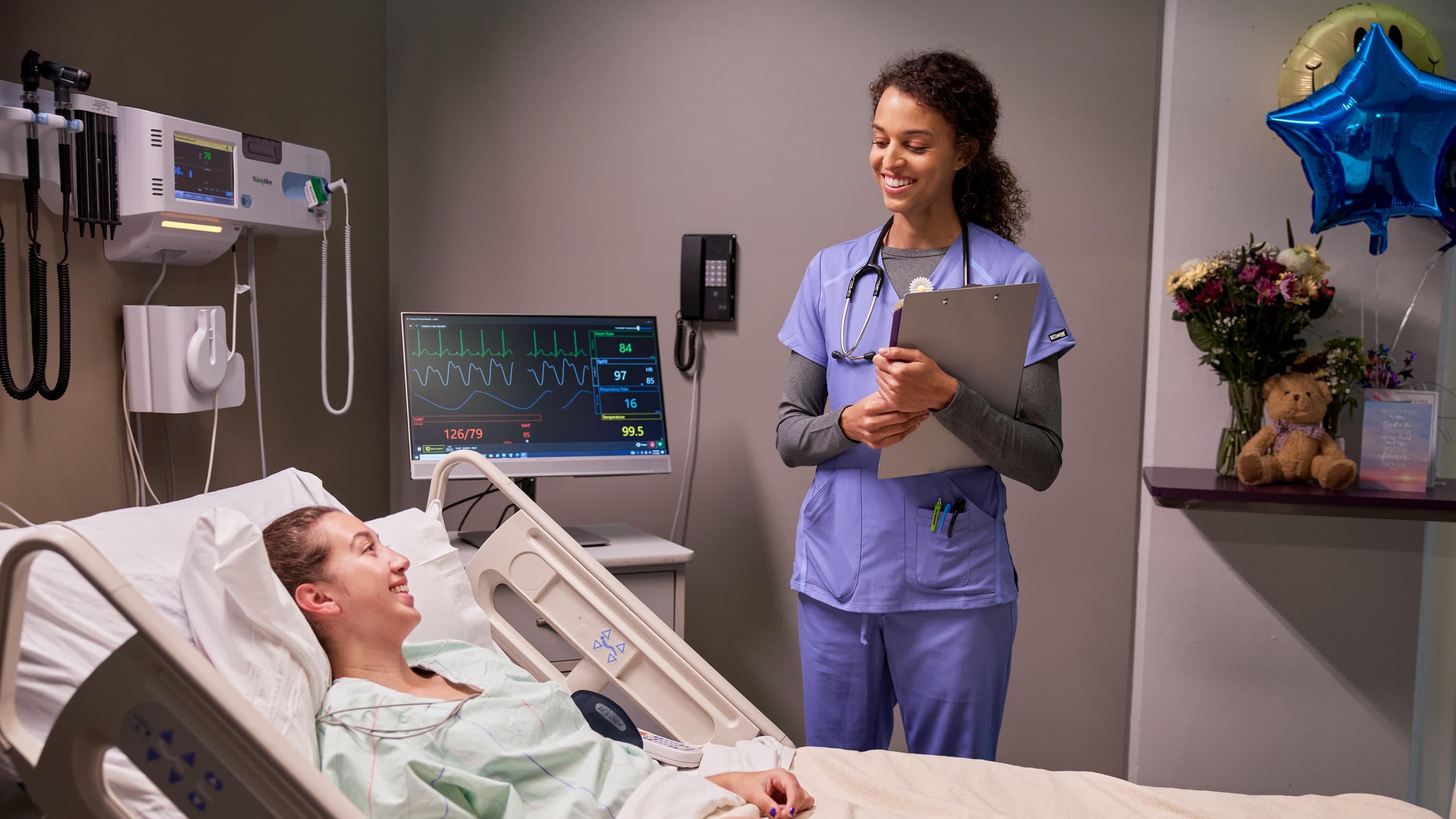 Student nurse helping out patient