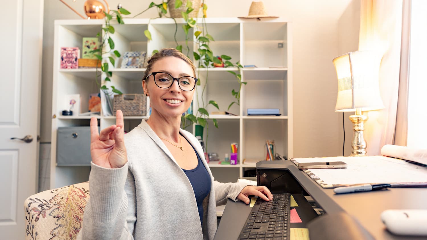 Woman at desk in home office applying for online elementary education degree