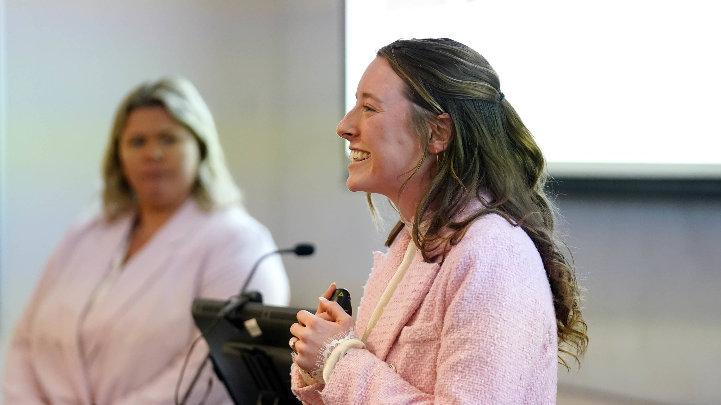 Female bachelor's in business degree student presenting research at GCU