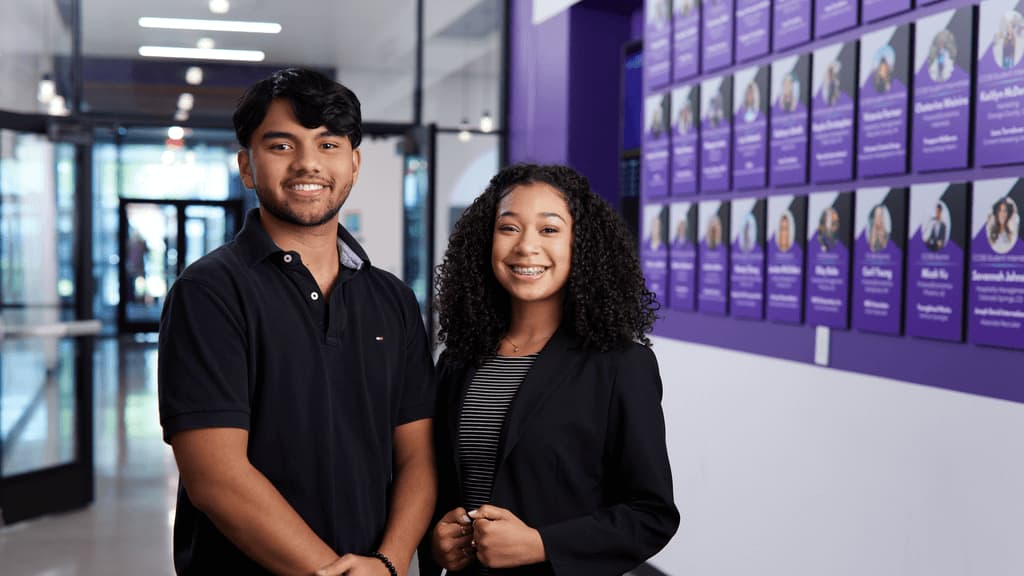 Male and female business degree students smiling in GCU's business college