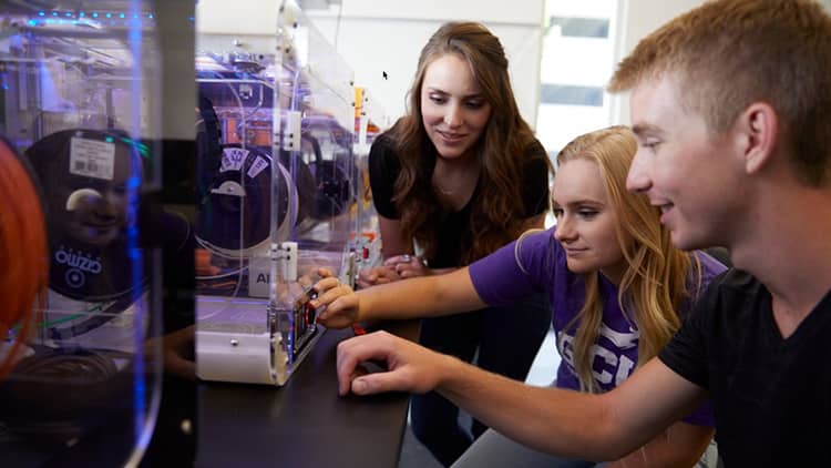 Students gather around a see through CPU