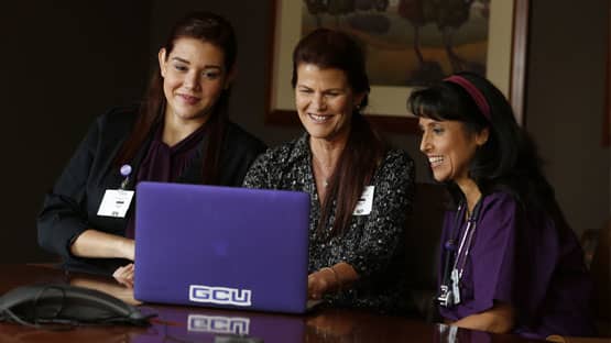 Nurses looking at a laptop