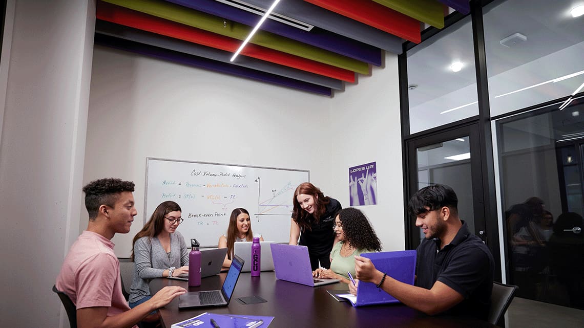 a group of students working together on a project for class