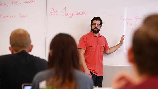 Instructor lecturing honors students