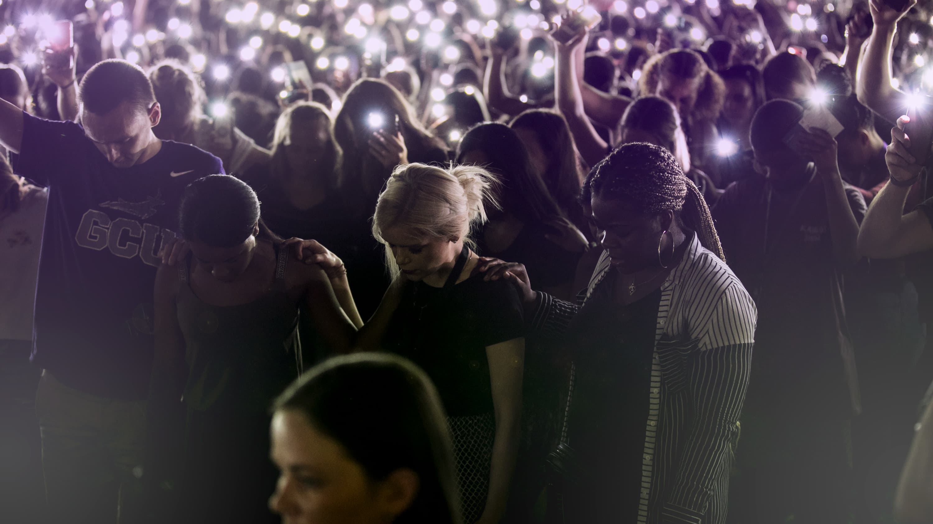 students praying at a GCU chapel service