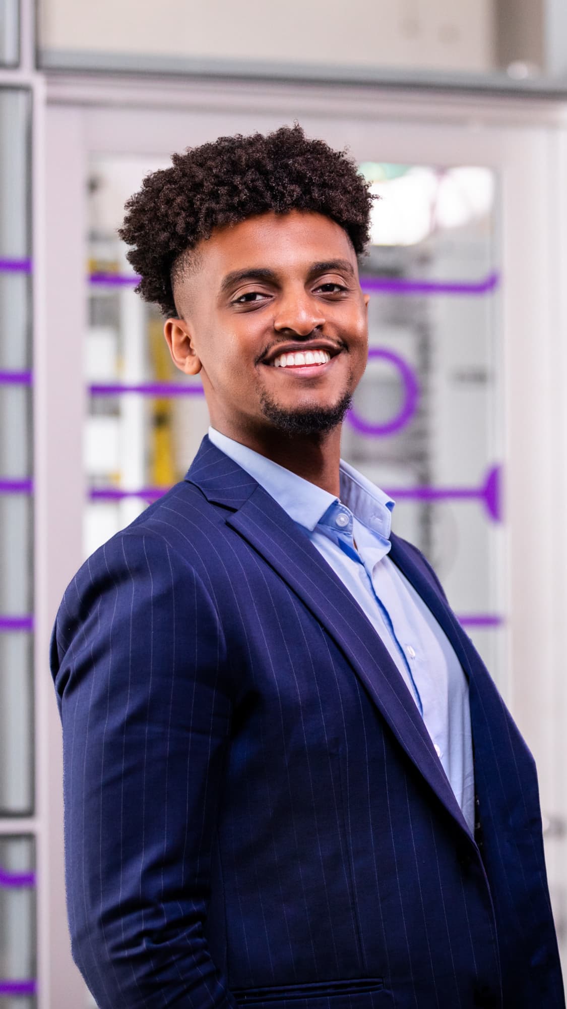 Male bridge program student smiling in GCU classroom