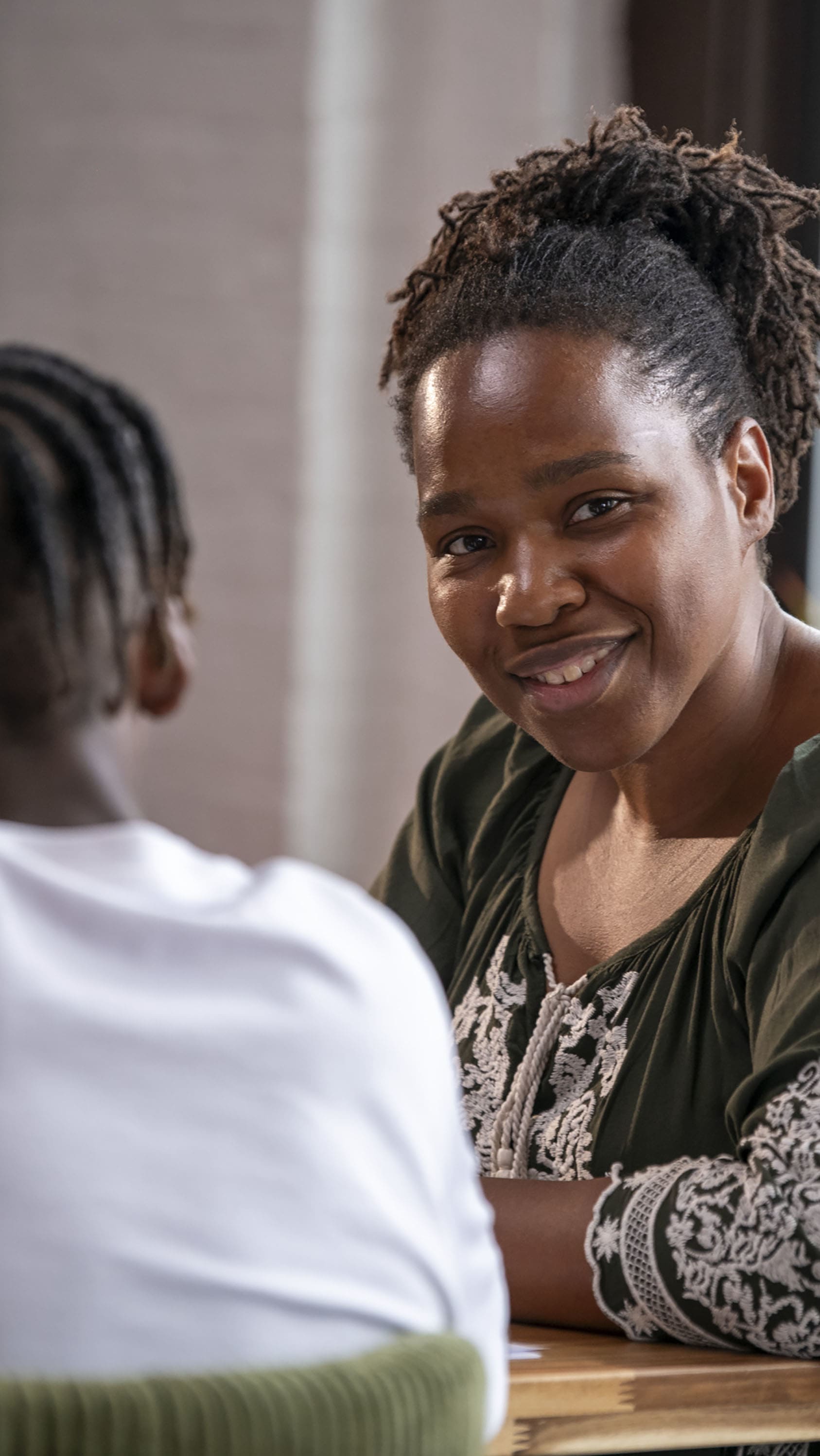 Keisha Ritchie smiling and teaching male elementary ed student