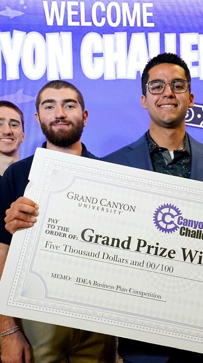 Canyon Challenge winners posing on stage with their prize check