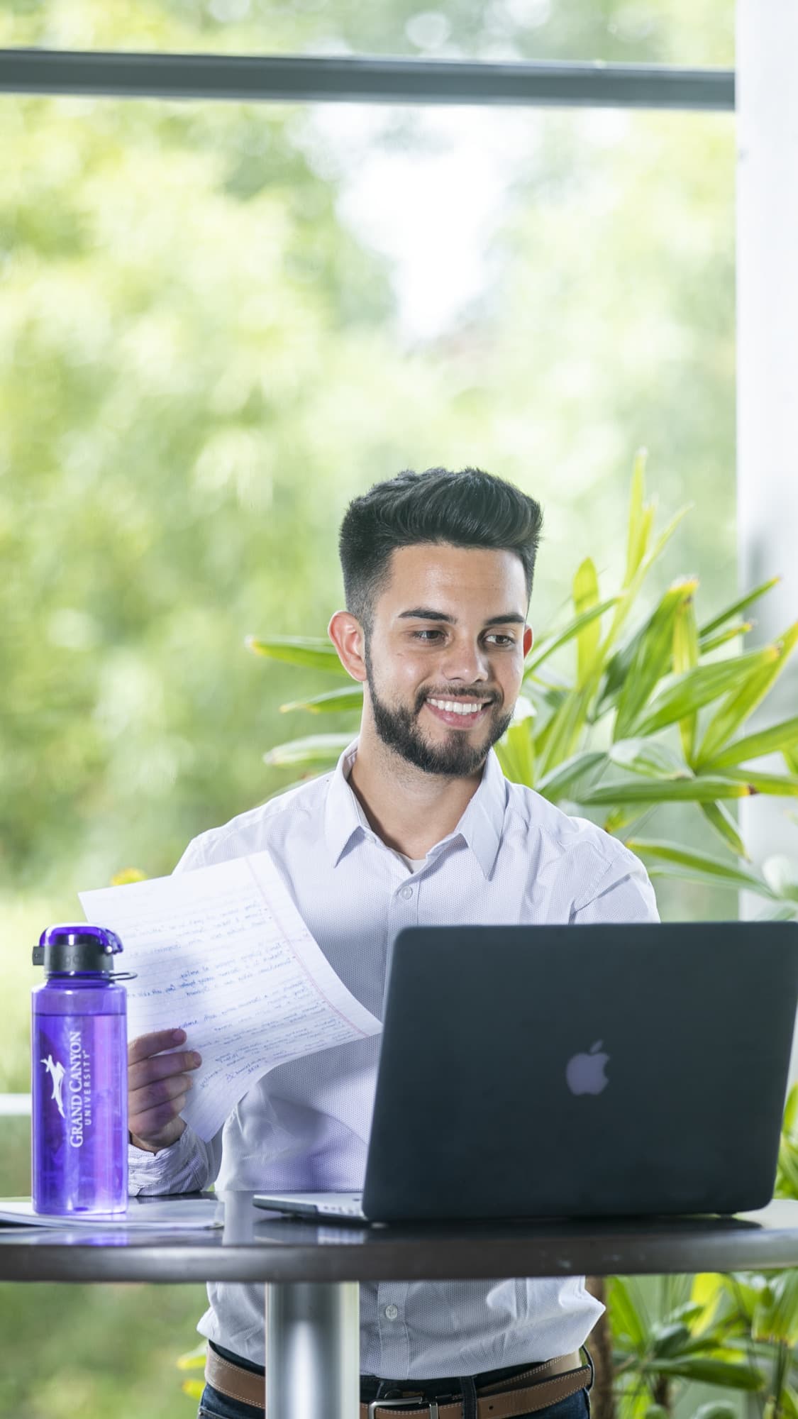 Male GCU student completing online degree coursework in office building