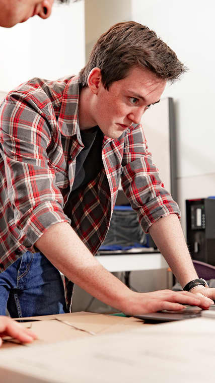 Software development students in class working on computers in a lab setting