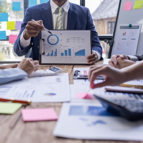 Accountants working together analyzing graphs and charts