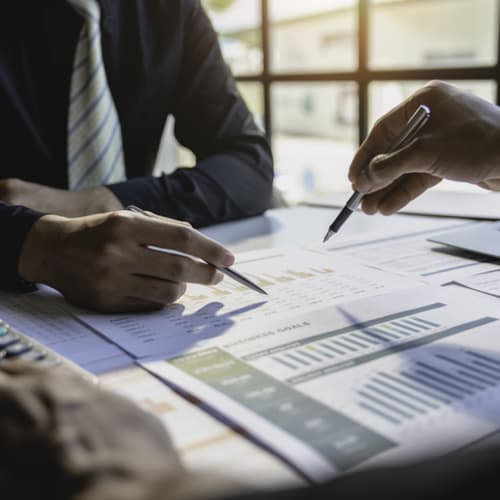 Business professionals analyzing graphs and charts together