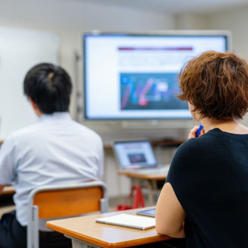Mid adult woman in a continuing education class at a community college or university - stock photo