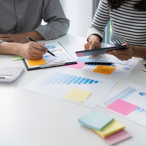policy analysts working on desk with charts