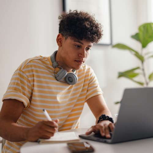 Young man works on his computer.