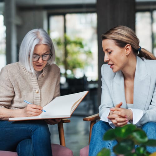 psychologist meeting with patient and writing notes