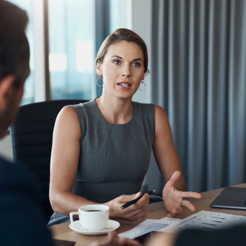 Woman speaks with her coworkers.