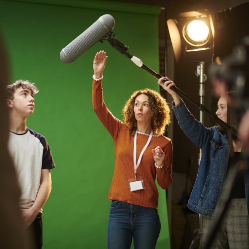 Film students in front of a green screen