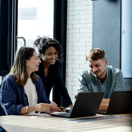 people surrounding computer at work